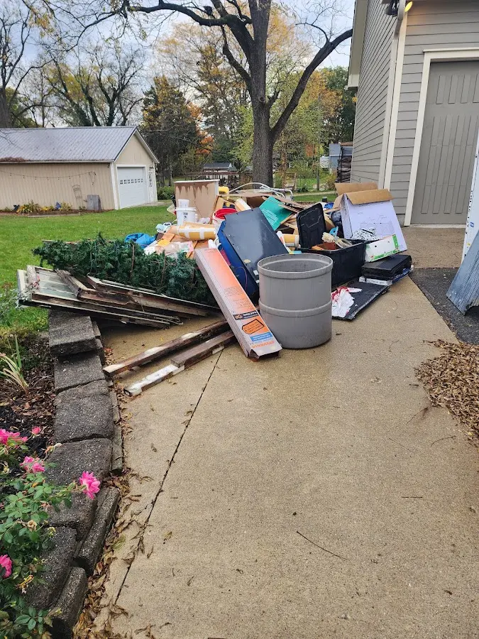 Dumpster being loaded with debris for 3 Yard Dumpster Rental in Bedford